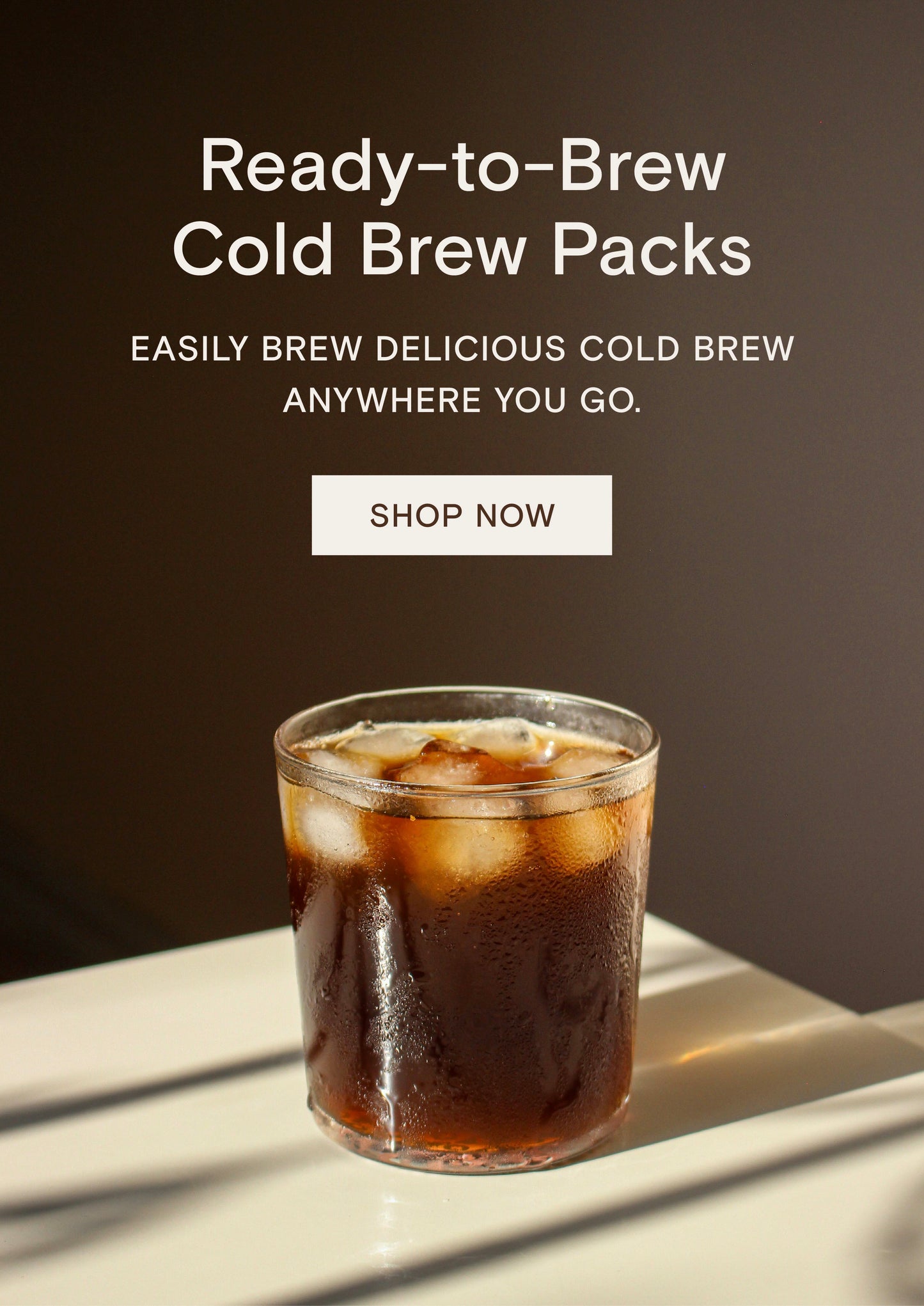 Glass of iced cold brew coffee with text promoting ready-to-brew cold brew packs and a Shop Now button above.