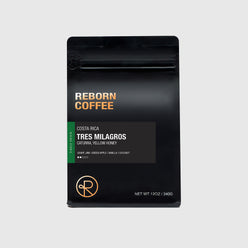 
                  
                    Reborn Coffee 12 oz coffee bag with information on Costa Rica Tres Milagros coffee beans. 
                  
                