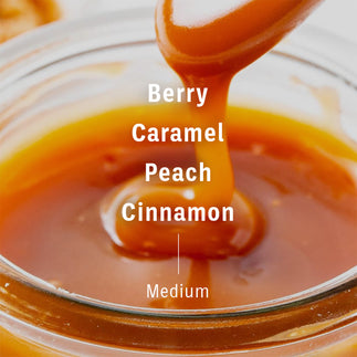 Flavor notes of Decaf Colombia, Condor Tolima on picture of caramel. Text reads berry, caramel, peach, cinnamon, medium.