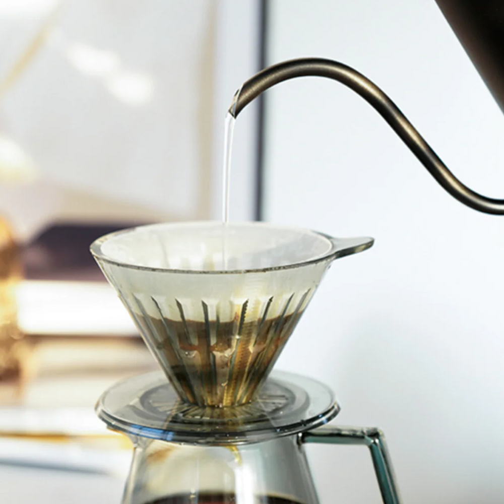 
                  
                    Timemore crystal eye dripper with paper filter and grounded coffee, water is being poured in by gooseneck kettle. 3 of 5.
                  
                