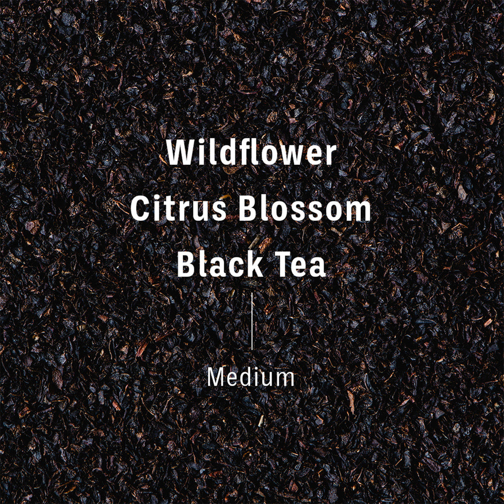 
                  
                    Flavor notes of XOXO blend, transposed on black tea. Text reads wildflower, citrus blossom, black tea, Medium. 
                  
                