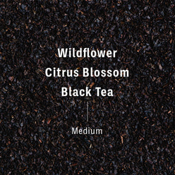 
                  
                     Flavor notes of XOXO blend, transposed on black tea. Text reads wildflower, citrus blossom, black tea, Medium.
                  
                