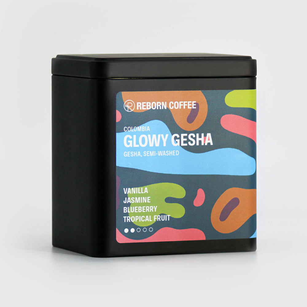 
                  
                    Black metal box with Glowy Gesha beans inside. Sticker shows product info imposed on colorful design. Front Left View, 3 of 4.
                  
                