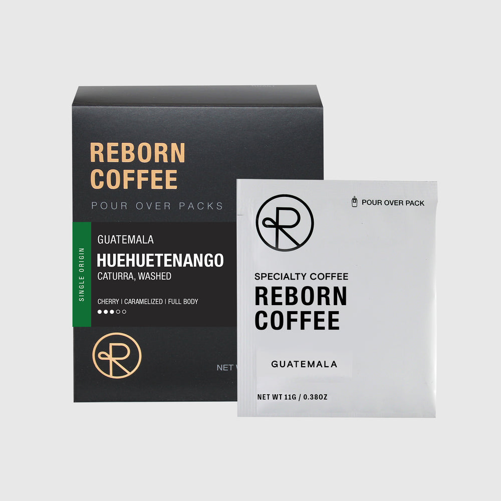 Guatemala Huehuetenango pour over pack box with product information on front sticker. Nitro sealed pour over pack bag next to box. 1 of 6.